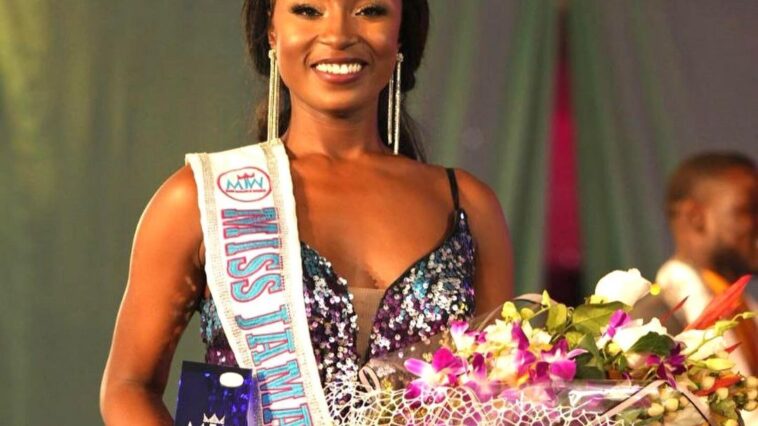 Tahje Bennett holds her award and flowers after being crowned the new Miss Jamaica World.