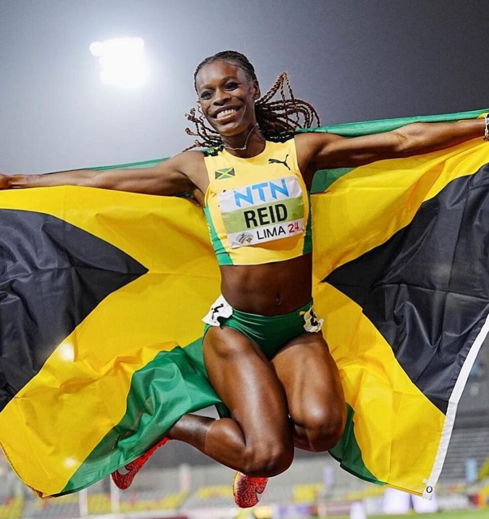Alana Reid celebrated after winning the U20 women's 100m World title.