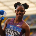 Tia Clayton holds a beanie after winning a race.