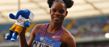 Tia Clayton holds a beanie after winning a race.