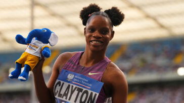 Tia Clayton holds a beanie after winning a race.