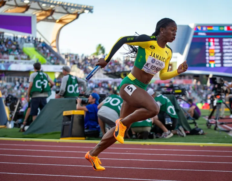 Kemba Nelson runs the relay for Team Jamaica at the 2022 IAAF World Championships.