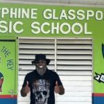 Chris Gayle stands in front of the Josephine Glasspole Basic School.