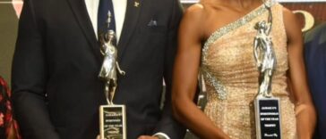 Roje Stona and Shaneika Ricketts hold their Sportsman and Sportswoman of the Year Awards.