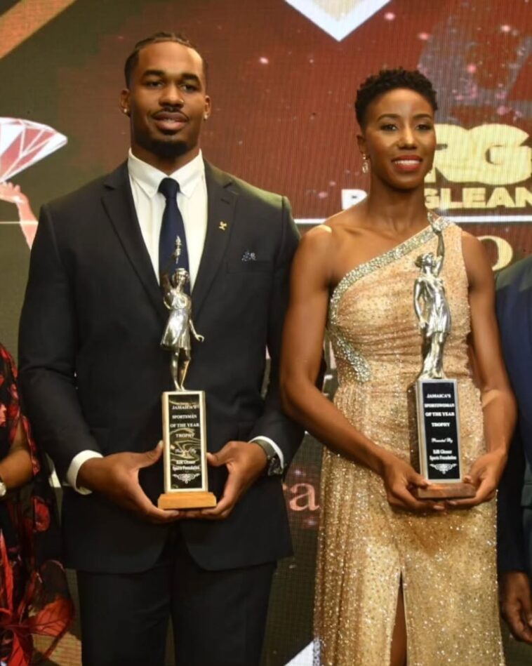 Roje Stona and Shaneika Ricketts hold their Sportsman and Sportswoman of the Year Awards.