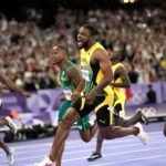 Kishane Thompson screams with joy after winning his semi-final at Paris 2024.