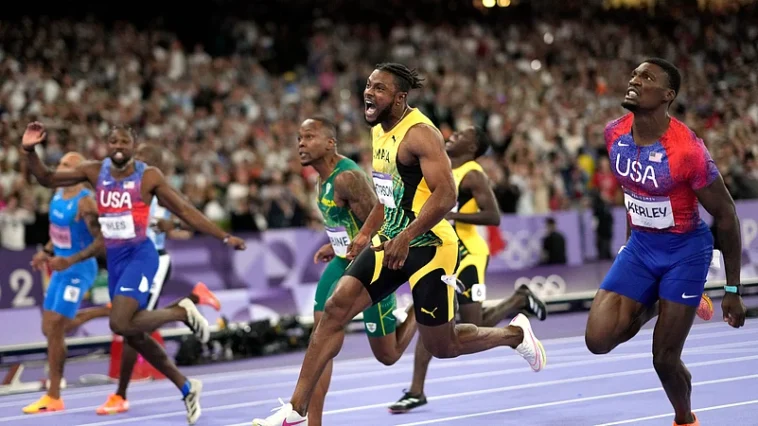 Kishane Thompson screams with joy after winning his semi-final at Paris 2024.