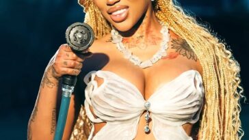 Jada Kingdom sprays a hose during the 'Only You' music video.