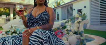 Shaneil Muir sips win in her new music video for Secured.