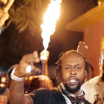 Popcaan performs in a music video.