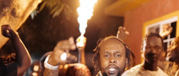 Popcaan performs in a music video.