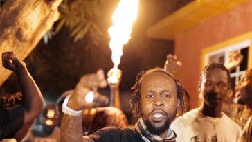 Popcaan performs in a music video.