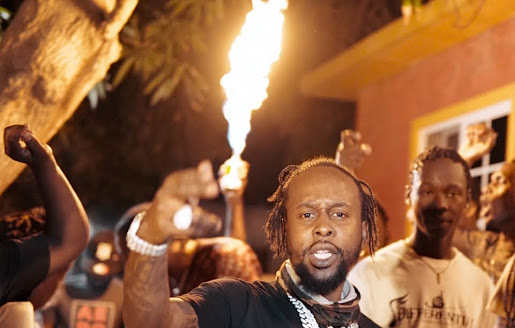 Popcaan performs in a music video.