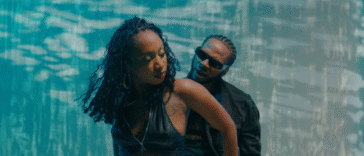 Dexta Daps dances with a woman on the set of the 'One Favor' music video.