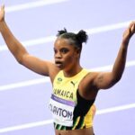 Tia Clayton raises her hands following her race at the 2024 Olympics