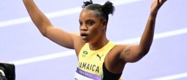 Tia Clayton raises her hands following her race at the 2024 Olympics