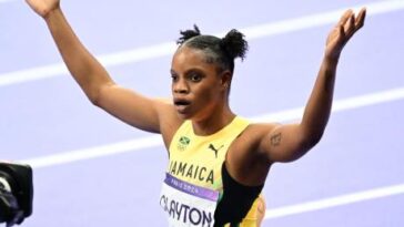 Tia Clayton raises her hands following her race at the 2024 Olympics