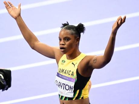 Tia Clayton raises her hands following her race at the 2024 Olympics