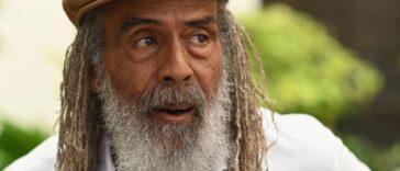 Allan Skill Cole looks on during an interview.