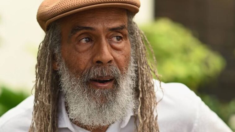 Allan Skill Cole looks on during an interview.