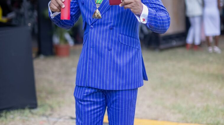 Yohan Blake accepts his national award, the Order of Distinction in the rank of Commander, on Oct. 20, 2025.