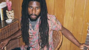 Chronixx poses with a guitar in a studio to promote his new album, "Exile."
