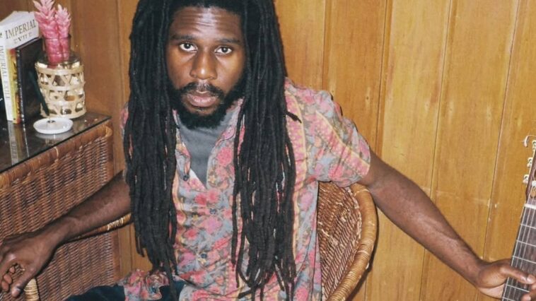 Chronixx poses with a guitar in a studio to promote his new album, "Exile."