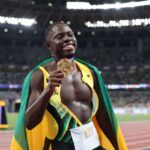 Olbique holds his men's 100m gold medal at the 2025 IAAF World Championships