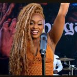 Shuga raises her hand during her 'Montego Bay' music video.