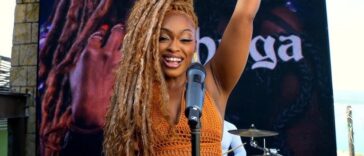 Shuga raises her hand during her 'Montego Bay' music video.