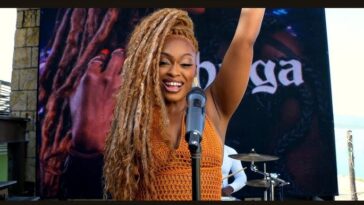Shuga raises her hand during her 'Montego Bay' music video.