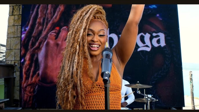 Shuga raises her hand during her 'Montego Bay' music video.