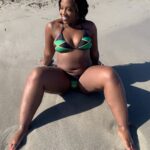 Dancer and OnlyFans model Empress Cece dresses up in a Jamaica-themed bikini while on the beach