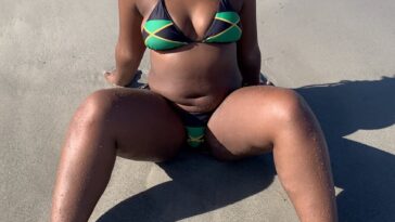 Dancer and OnlyFans model Empress Cece dresses up in a Jamaica-themed bikini while on the beach