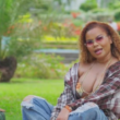 Ce'Cile sits in the park during the music video for "Baddest Love"