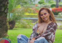 Ce'Cile sits in the park during the music video for "Baddest Love"
