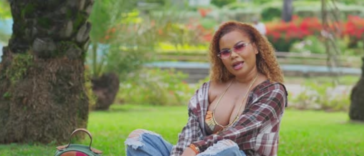 Ce'Cile sits in the park during the music video for "Baddest Love"