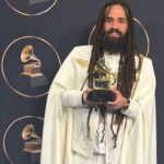 Keznamdi shows off his newly-won Grammy on the red carpet at the 68th Grammy Awards