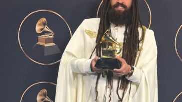 Keznamdi shows off his newly-won Grammy on the red carpet at the 68th Grammy Awards