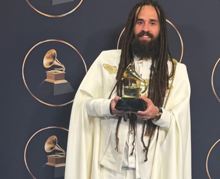Keznamdi shows off his newly-won Grammy on the red carpet at the 68th Grammy Awards