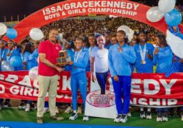 Edwin Allen athletes celebrates their Issa Girls Champs trophy.