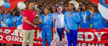 Edwin Allen athletes celebrates their Issa Girls Champs trophy.