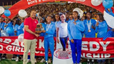 Edwin Allen athletes celebrates their Issa Girls Champs trophy.
