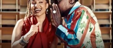 Shenseea receives a message from Vybz Kartel during their music video for "Talk To Me Nuh."