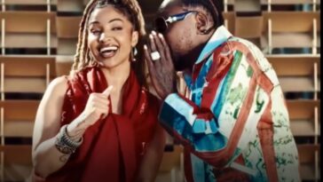 Shenseea receives a message from Vybz Kartel during their music video for "Talk To Me Nuh."
