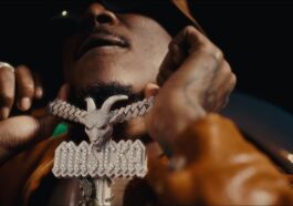 Masicka shows off his GOAT chain during the music video for "Boasty."