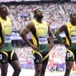 Kishane Thompson reflects with his teammates after the 4x100m relay at the 2024 Olympic Games.