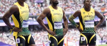 Kishane Thompson reflects with his teammates after the 4x100m relay at the 2024 Olympic Games.