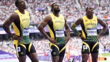 Kishane Thompson reflects with his teammates after the 4x100m relay at the 2024 Olympic Games.