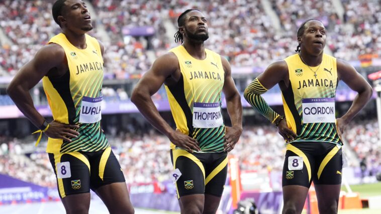 Kishane Thompson reflects with his teammates after the 4x100m relay at the 2024 Olympic Games.